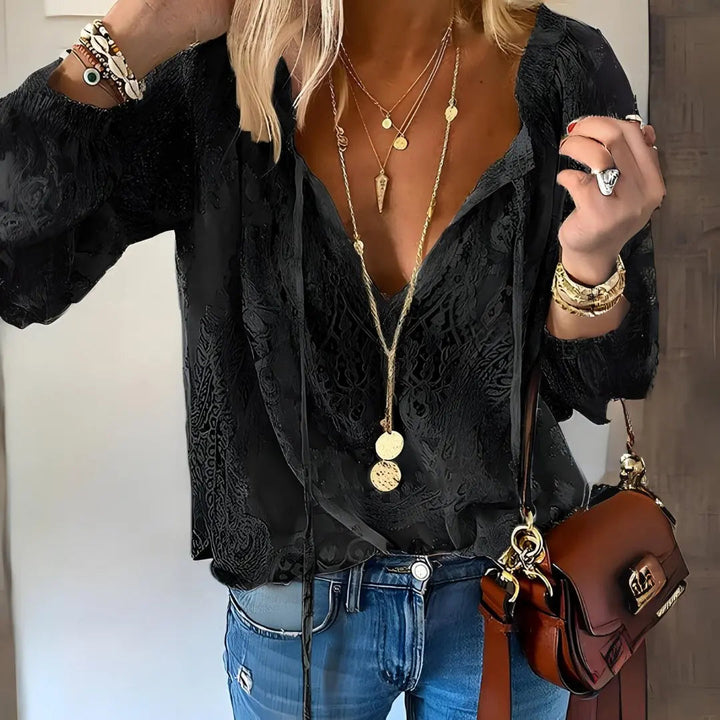 Flowy women's boho lace blouse featuring delicate crochet details and a stylish deep V-neck.