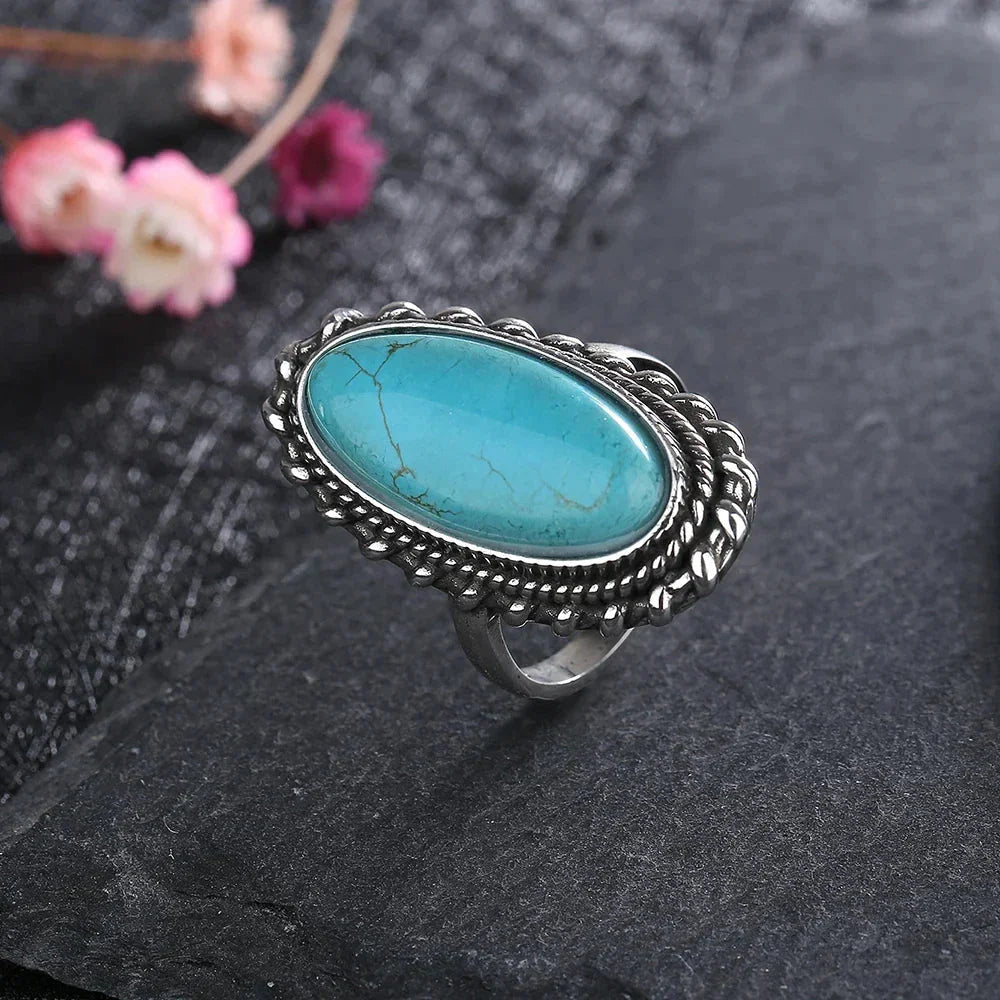 Women's boho oval turquoise ring with braided silver-tone setting, a unique statement piece.