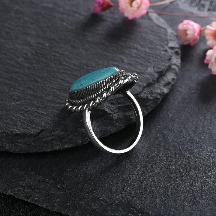 Gift for her: a beautiful women's boho oval turquoise ring with a handcrafted braided silver setting.