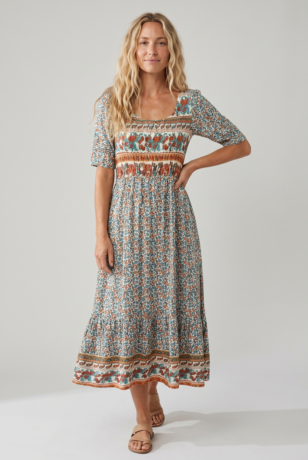 Free-spirited tiered midi dress, bohemian print, flattering shirred top, sleeveless.