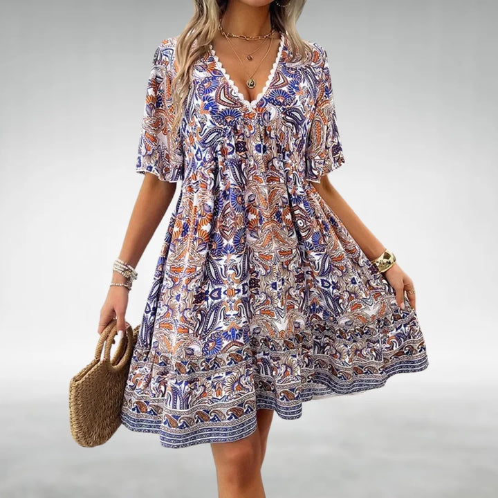 Chic women's printed boho mini dress, short & casual, with V-neck & flutter sleeves for summer.