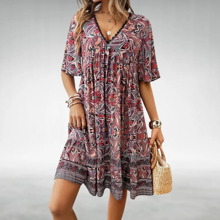 Stylish printed boho mini dress for women, featuring a flattering V-neck & delicate flutter sleeves.