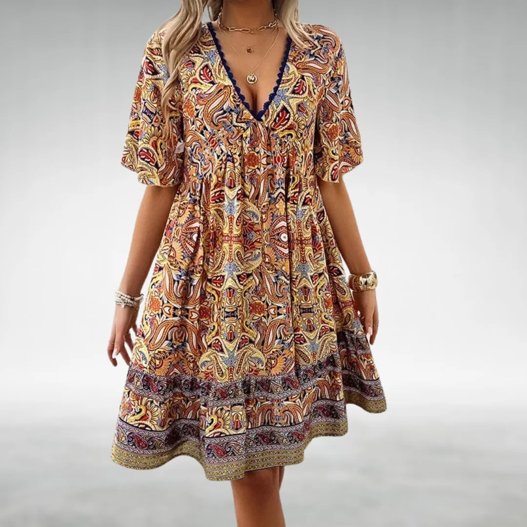 Vibrant women's boho printed mini dress. Features V-neck, flutter sleeves. Ideal for summer casual wear.
