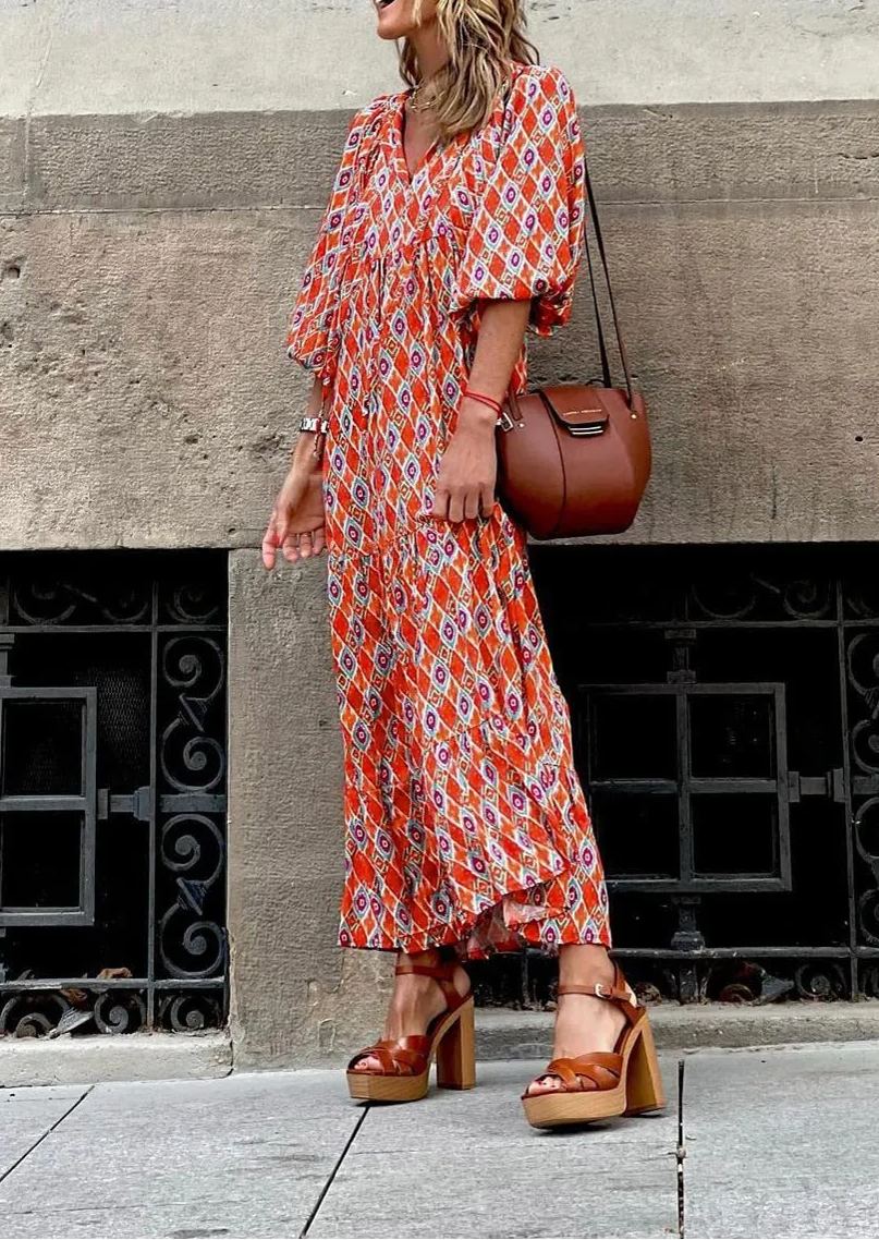 Elegant women's bohemian maxi dress with puff sleeves, V-neck, and a beautiful floral pattern.