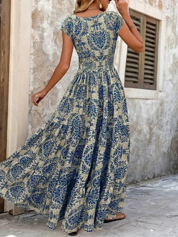 Chic women's boho tiered maxi dress, smocked bodice, V-neck cap sleeves, vibrant summer print.