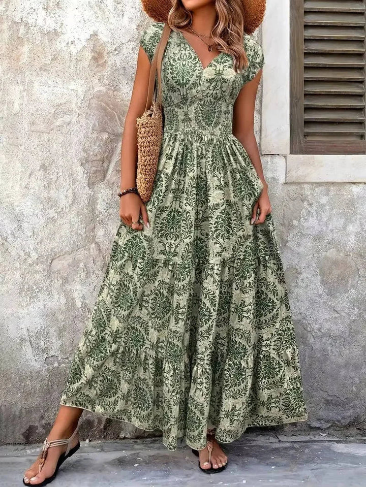 Elegant women's bohemian maxi dress, smocked tiered design with V-neck cap sleeves. Summer fashion.