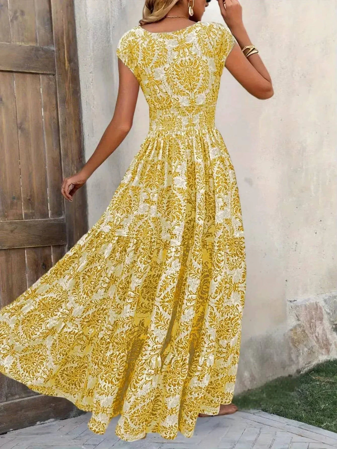 Stylish women's tiered smocked maxi dress with V-neck cap sleeves, ideal for bohemian summer outfits.