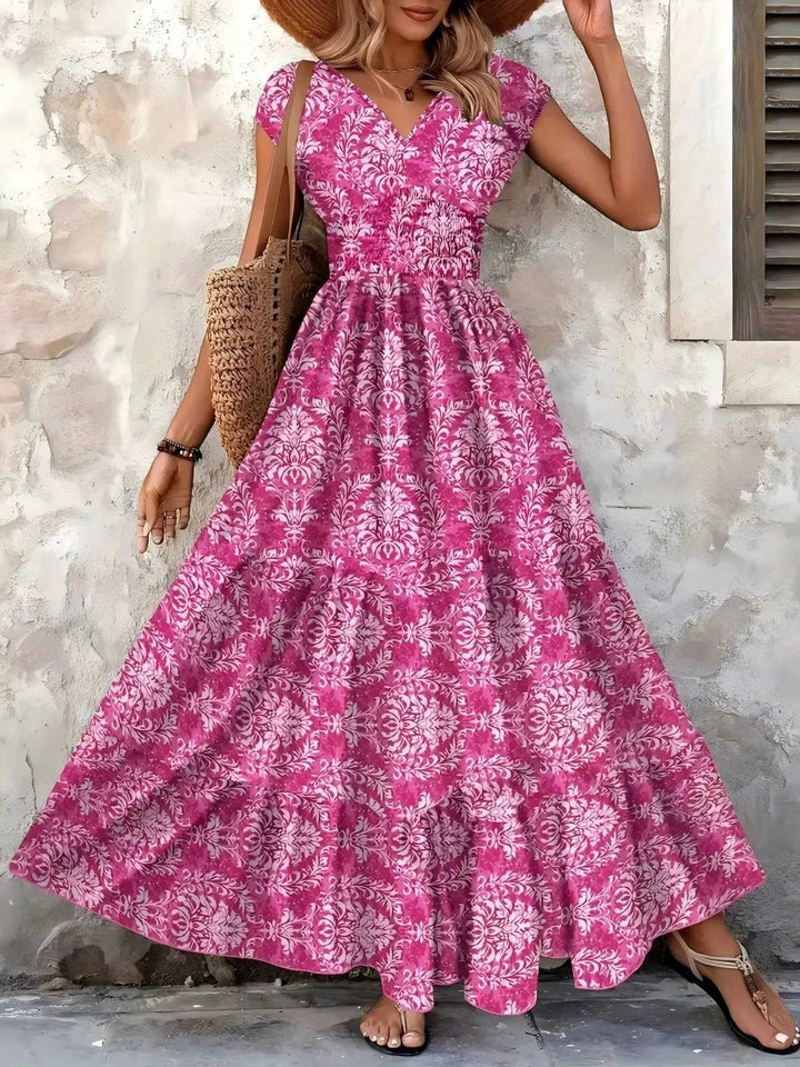 Flowy boho maxi dress for women, smocked tiered, V-neck cap sleeves. Perfect for summer events.