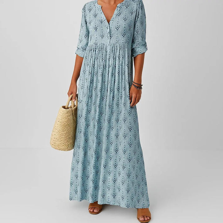 Women's boho V-neck maxi dress with roll-up sleeves. Flowy printed bohemian summer dress, perfect for casual wear.