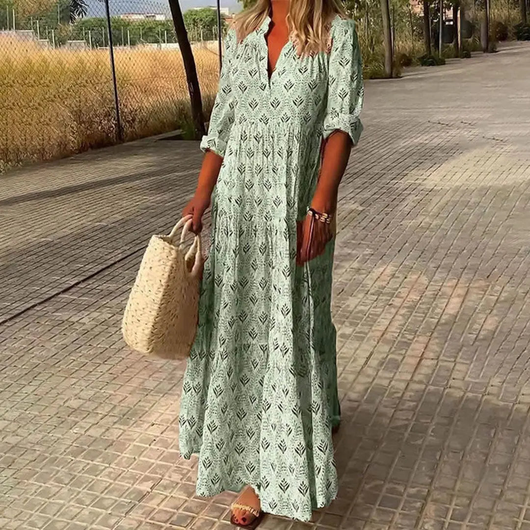 Stylish women's bohemian maxi dress. Printed V-neck design with practical roll-up sleeves, great for summer fashion.