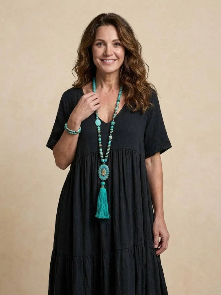 Casual women's V-neck tiered maxi dress, short sleeve, ideal for beach wear.