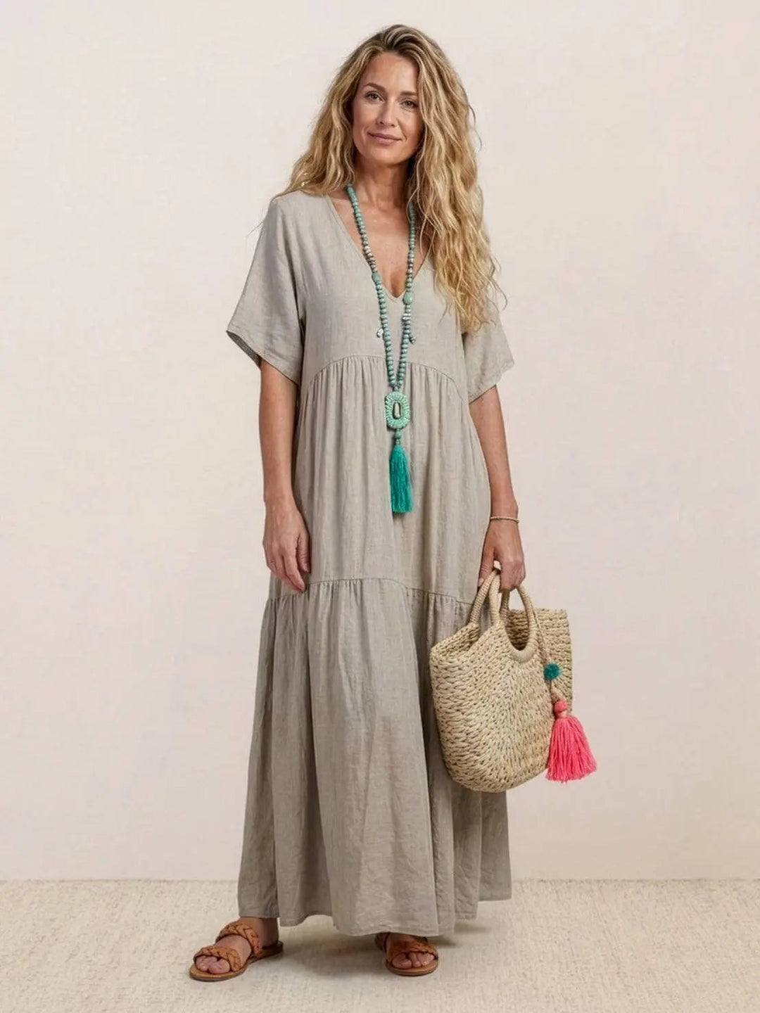 Elegant V-neck tiered maxi swing dress for women, great for resort wear.
