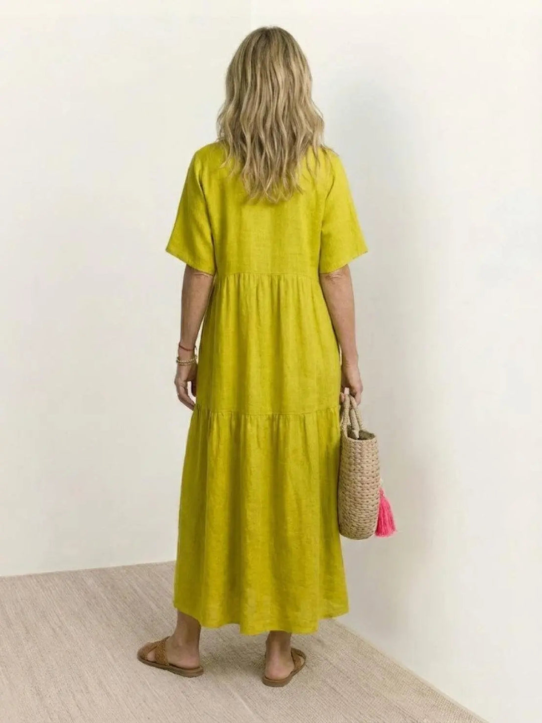 Women's flowy boho V-neck tiered maxi swing dress, ideal for summer comfort.