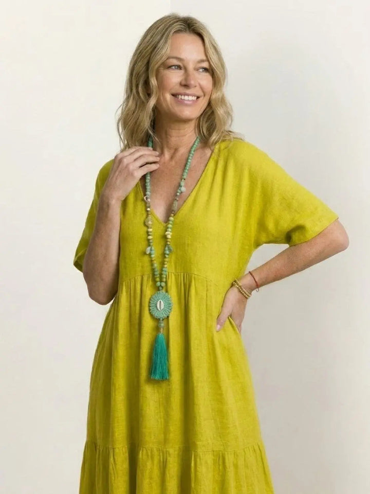 Bohemian women's summer dress, V-neck tiered maxi, perfect for beach trips.