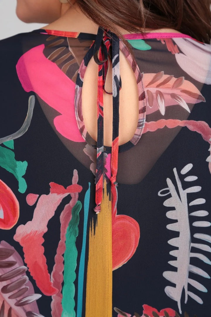 Close-up of the bold floral print on a long-sleeve women's midi dress, highlighting fabric detail.