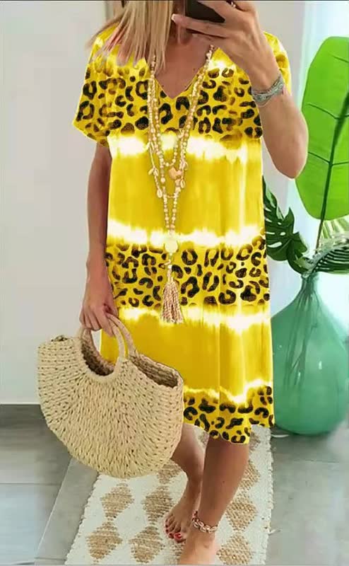Comfortable women's short sleeve v-neck shift dress featuring a stylish bold print; a vibrant summer essential.