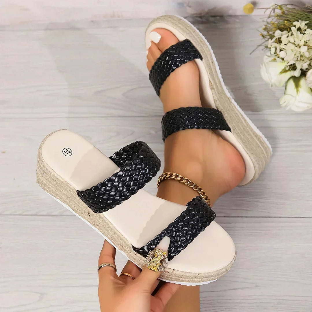 Stylish women's espadrille wedge sandals with braided design. Cushioned slip-on for chic summer comfort.