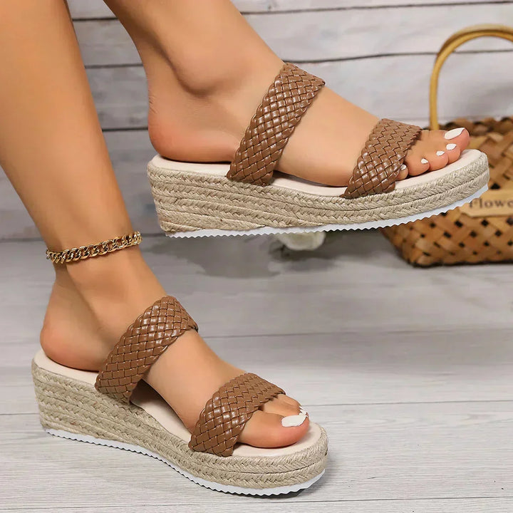 Women's braided wedge sandals. Cushioned, slip-on design offers ultimate comfort for chic summer espadrille style.