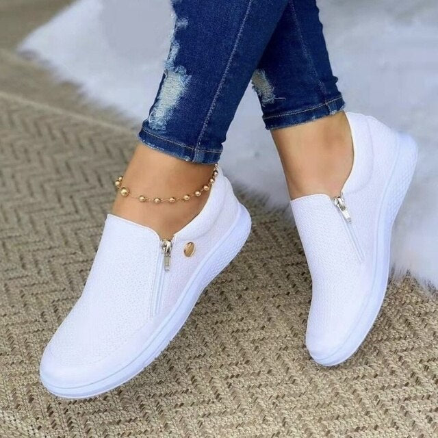 Trendy women's slip-on platform sneakers featuring a breathable upper and practical side zip closure.