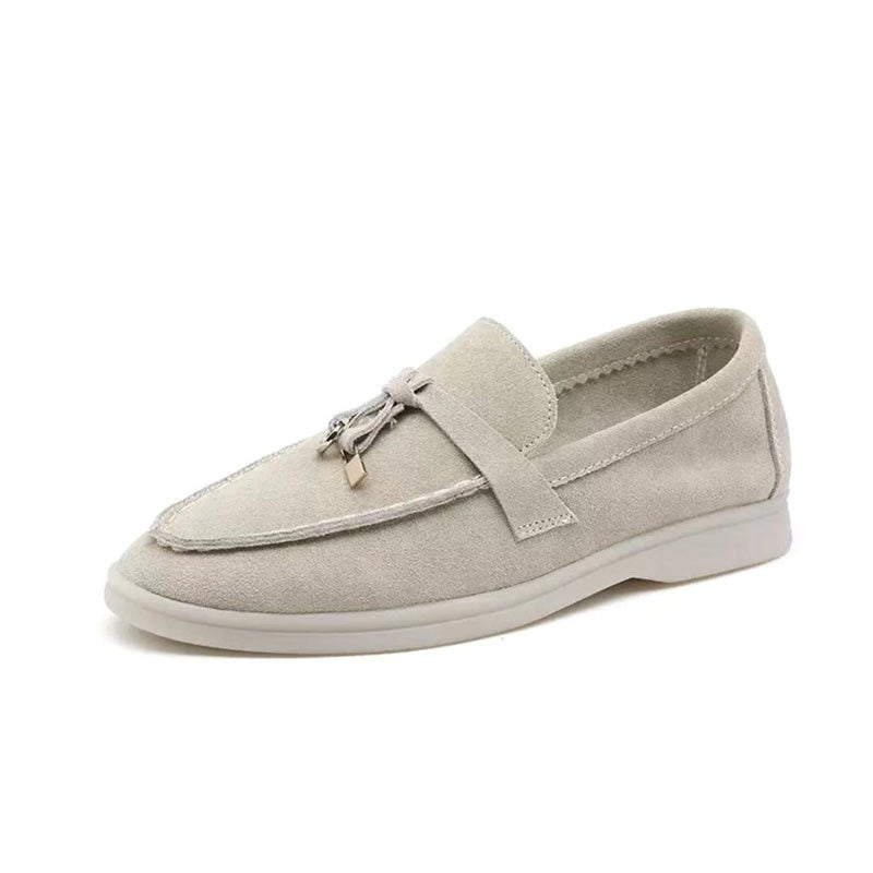 Woman wearing elegant pointed toe slip-on loafers. Comfortable and breathable flats for a casual chic look.