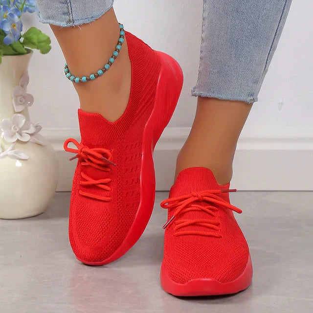 Women's breathable slip-on sneakers in white, ideal for everyday wear.