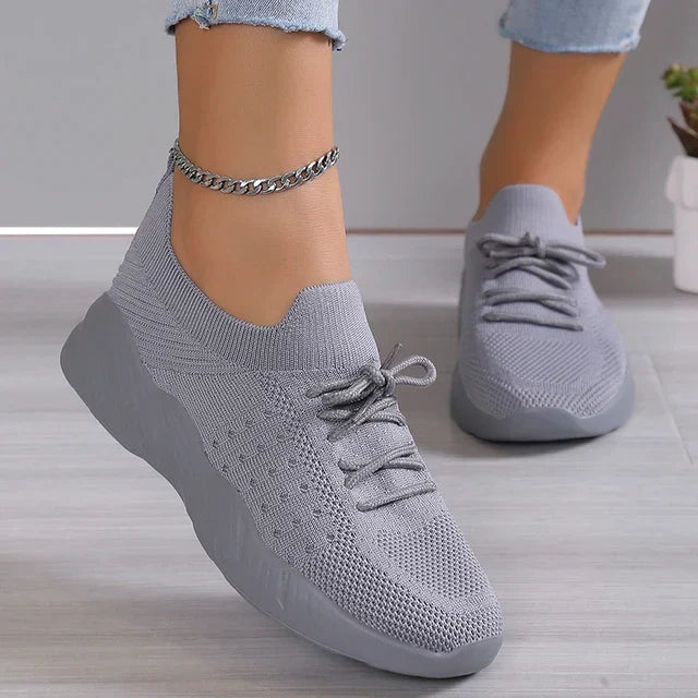 Close-up of the breathable mesh fabric on women's slip-on sneakers.