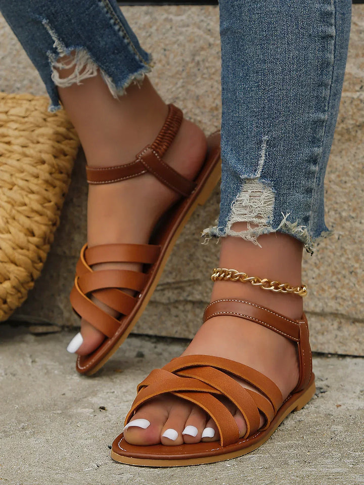 Comfortable women's slip-on flat sandals with open toe & elastic heel for easy everyday summer wear.