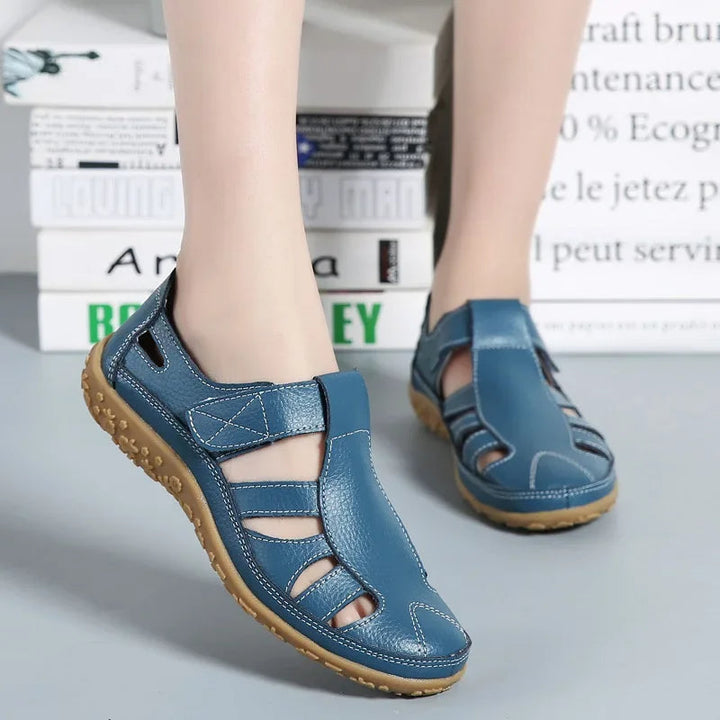 Close-up of adjustable velcro strap on women's comfort leather sandals.