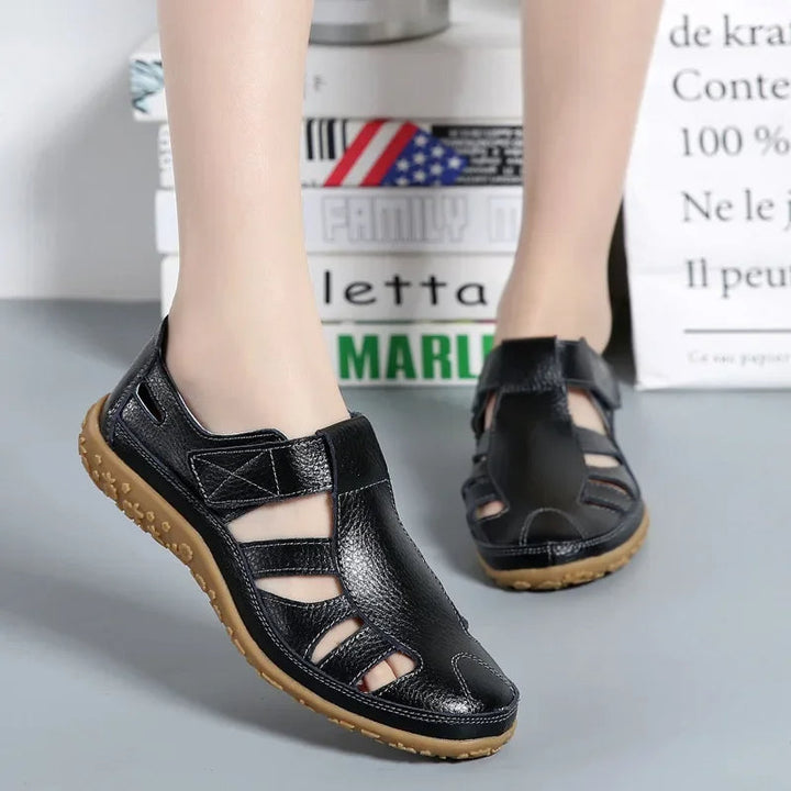 Stylish black leather sandals for women with cushioned comfort sole.