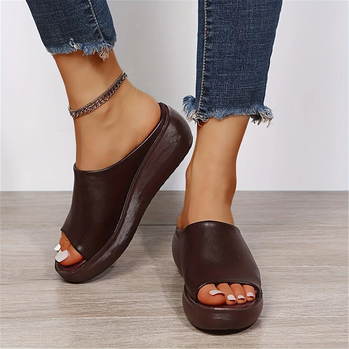 Lightweight women's brown open-toe wedge sandals, designed for ultimate comfort and effortless slip-on wear.