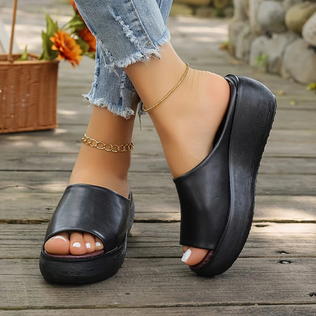 Fashionable brown women's wedge sandals with an open-toe, perfect for a chic and comfortable summer look.