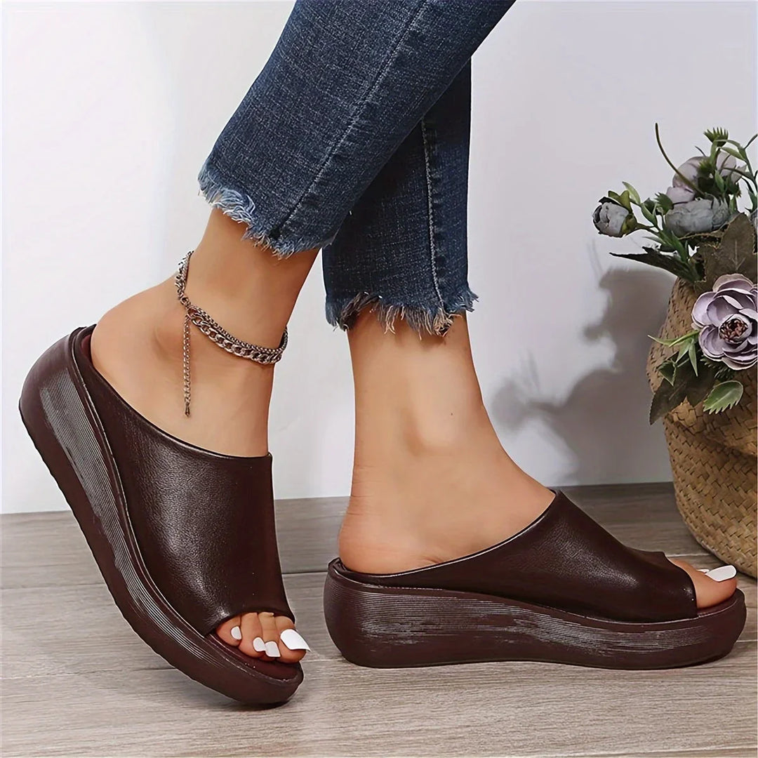 Casual brown wedge sandals for women, featuring a convenient slip-on style and breathable open-toe design.