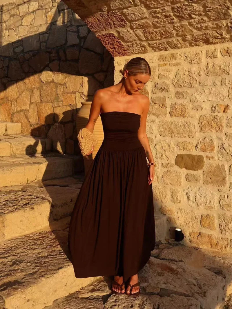 Long brown strapless pleated maxi dress for women, an elegant and flowy summer or evening party dress.