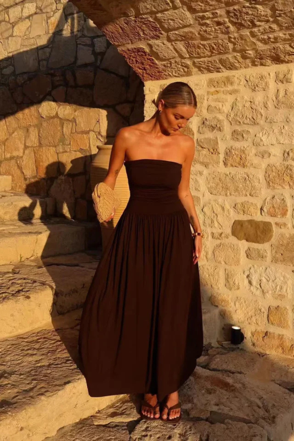 Elegant women's brown strapless pleated maxi dress, a perfect flowy long dress for summer evening parties.