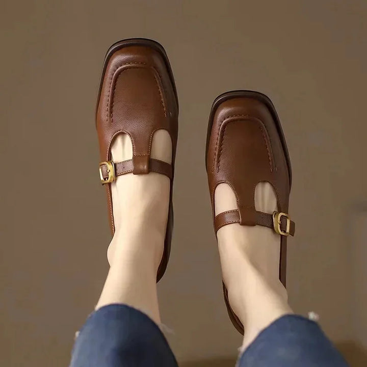 Woman wearing stylish brown T-Strap Mary Jane block heel shoes, great for elegant workwear outfits.