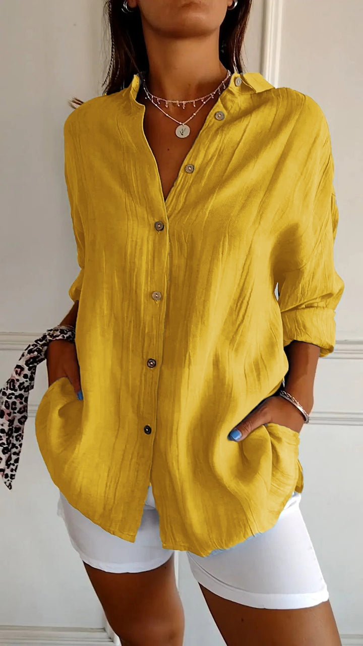 Fashionable women's long sleeve button-down blouse, essential for a versatile wardrobe.