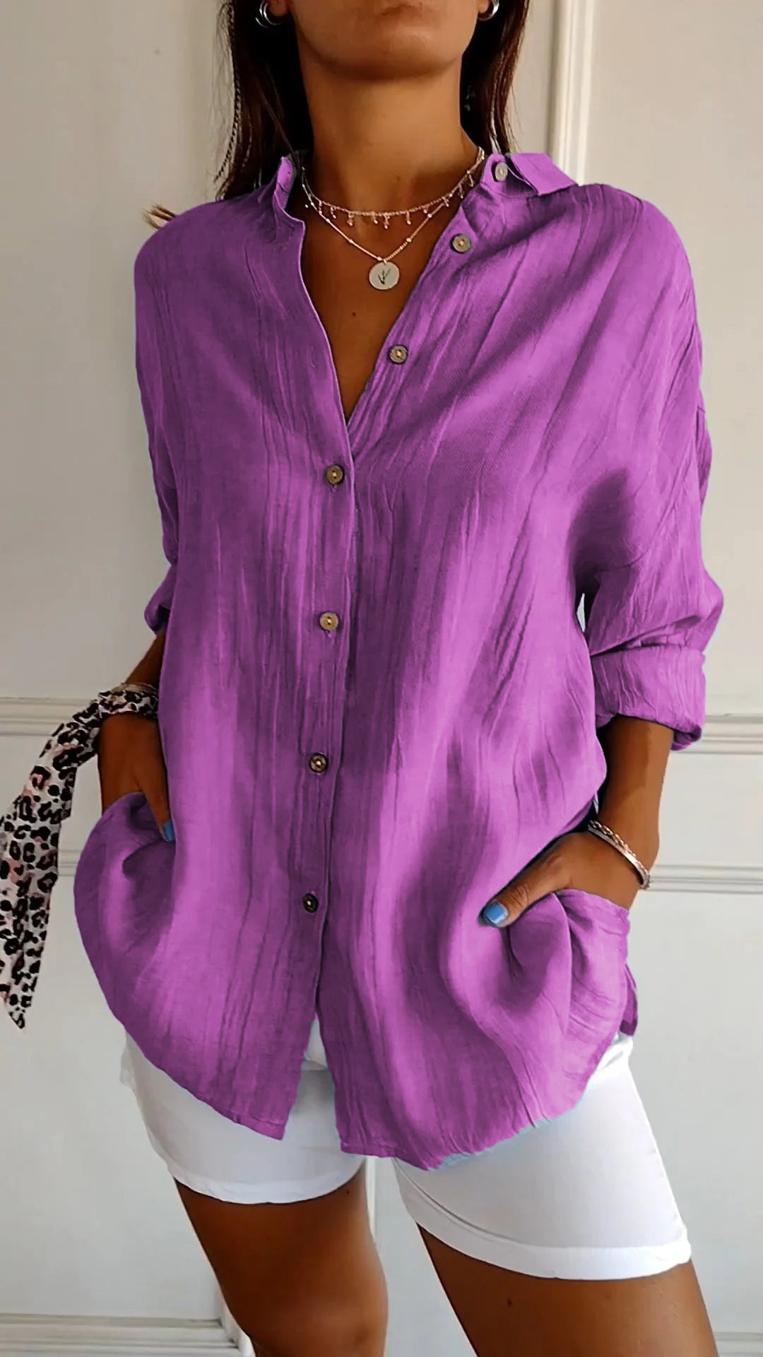 Women's button-down long sleeve blouse with crinkled texture, great for summer style and comfort.