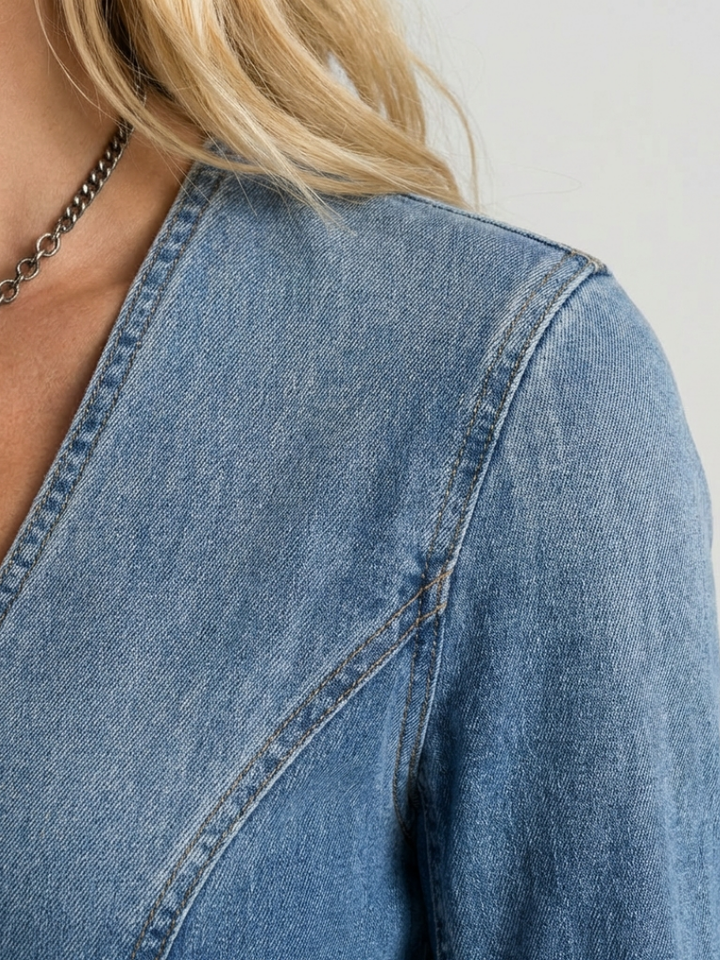 Comfortable women's floor-length denim maxi dress. Features a button front, long sleeves, and V-neck for versatile styling.