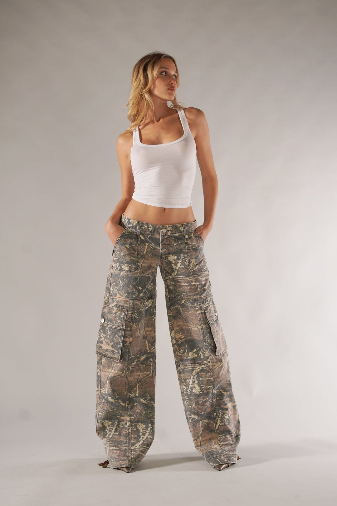 Relaxed fit women's camouflage cargo pants. Stylish utility trousers with wide leg for comfortable spring/autumn casual wear.