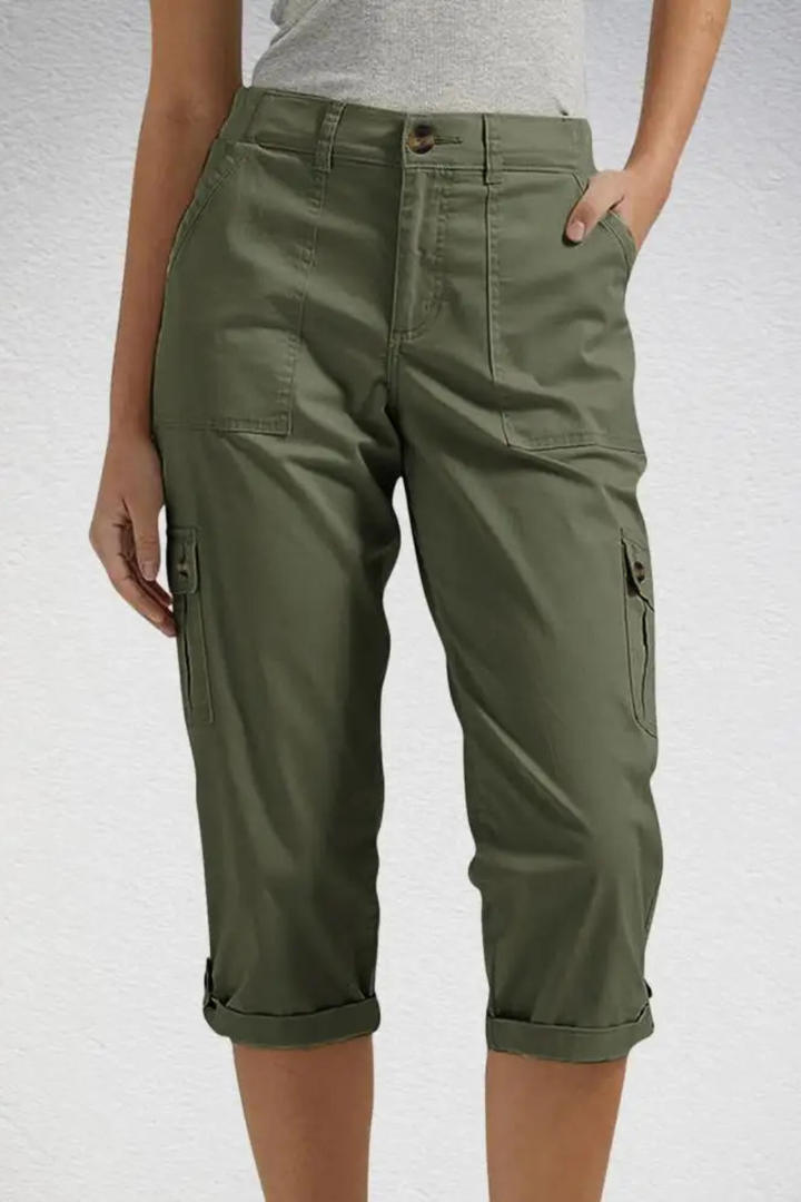 Back view of women's casual cargo cropped trousers, emphasizing the multi-pocket and roll-up hem.