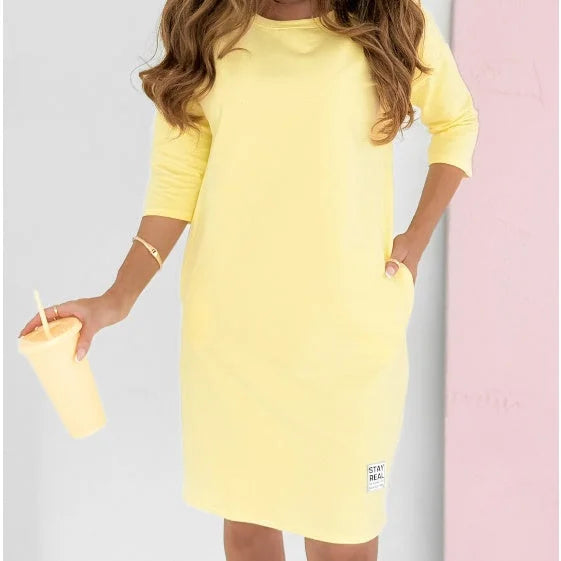 Women's 3/4-sleeve mini dress with crew neck & essential pockets, designed for relaxed spring & summer comfort.