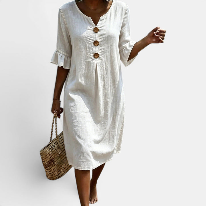 Stylish women's midi shift dress with a button-front design, round neck, & half sleeves. Ideal for casual wear.