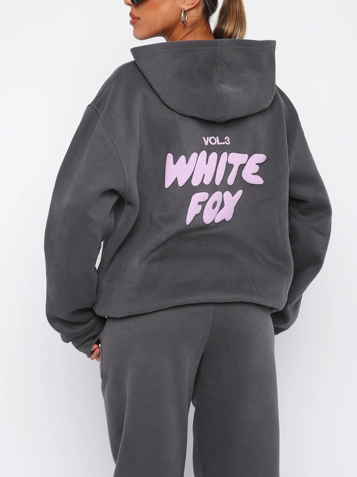 Active lifestyle women's cropped tracksuit: trendy hoodie & joggers set with unique back graphic.
