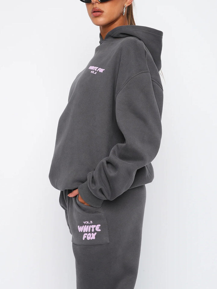 Women's athletic-casual cropped tracksuit. Two-piece set with a comfy hoodie & joggers, plus a stylish back print.