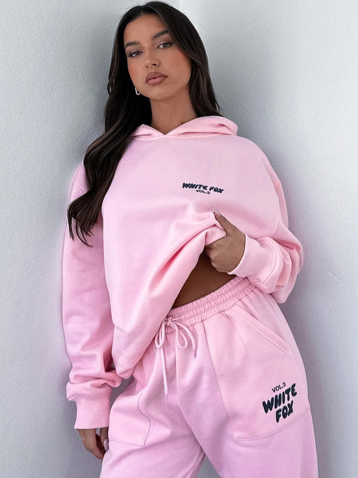 Comfy women's cropped tracksuit: matching hoodie & joggers with a unique back print. Trendy casual loungewear set.