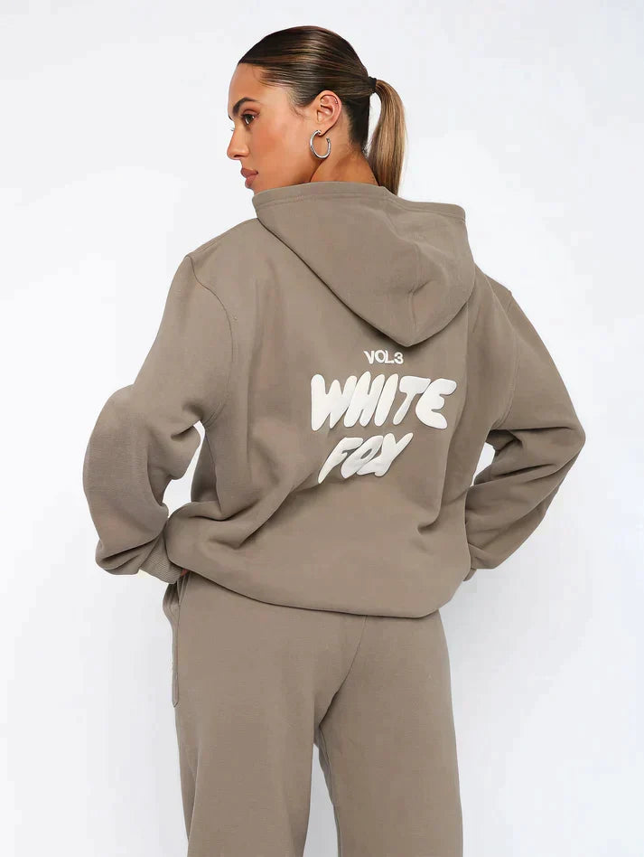 Modern women's casual set: a cropped hoodie and jogger combo with a distinctive back print detail.