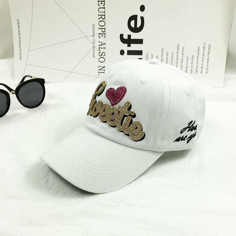 Colorful embroidered "sweetie" design baseball cap for women, offering a comfortable, adjustable fit & fashion.