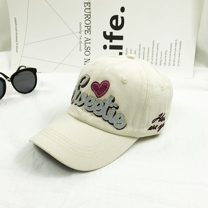 Embroidered women's casual baseball cap, adjustable fit, made of cotton for comfort, fashion & sun protection.