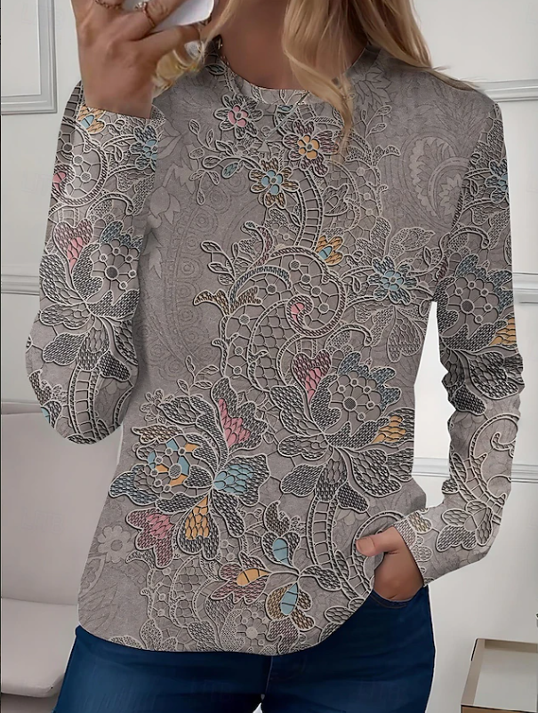 Detailed floral pattern on a women's long sleeve crew neck blouse, a soft and casual top for versatile styling.