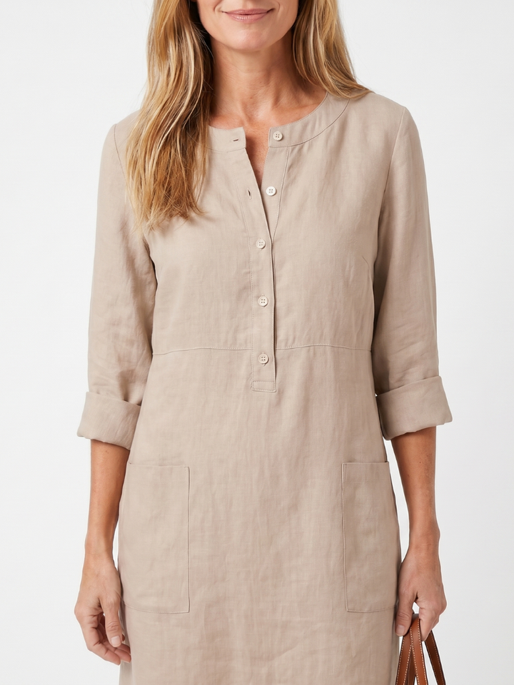 Round neck women's knee-length casual dress with 3/4 sleeves, button front & pockets.